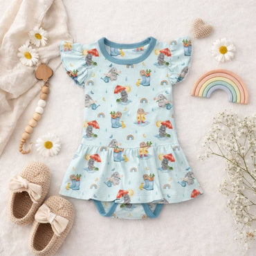Baby girl bamboo bodysuit twirl with bunny and rainbow pattern on a light background.