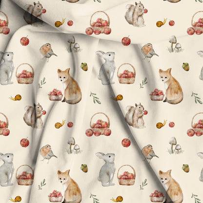 Bamboo viscose fabric woodland and orchard print. Woodland animal repeated pattern with apples and fall animals on a soft beige background. 